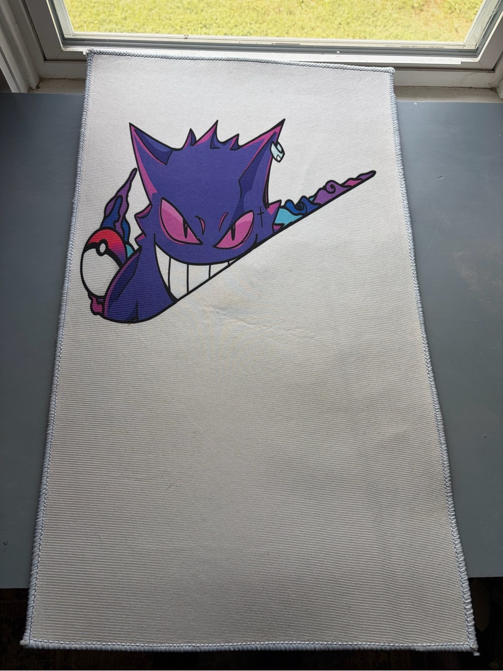 White Bath Mat with Purple Character Graphic